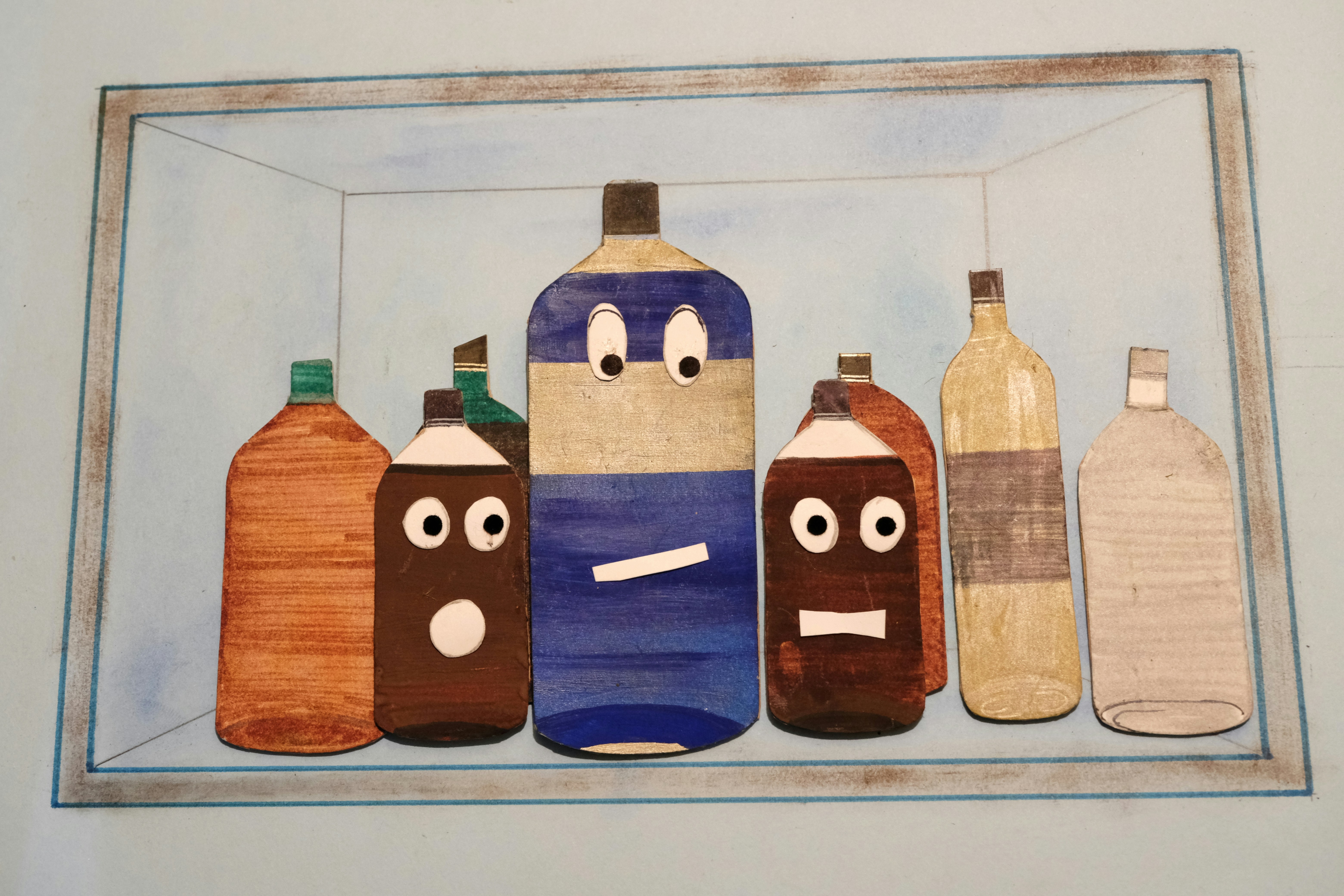 A picture of a group of bottles with faces drawn on them