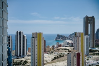 A group of tall buildings next to a body of water