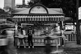 A black and white photo of a food stand