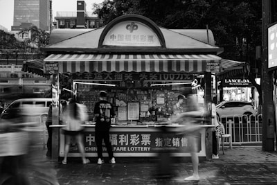 A black and white photo of a food stand