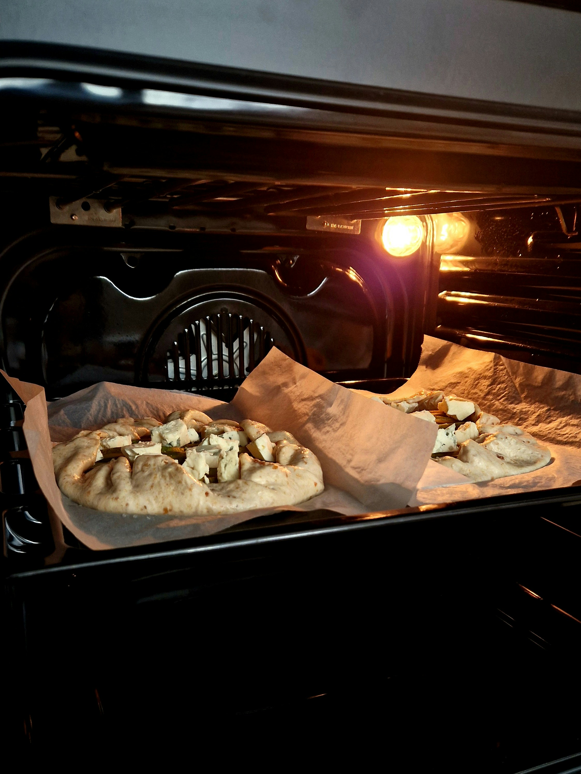 A couple of trays of food in an oven