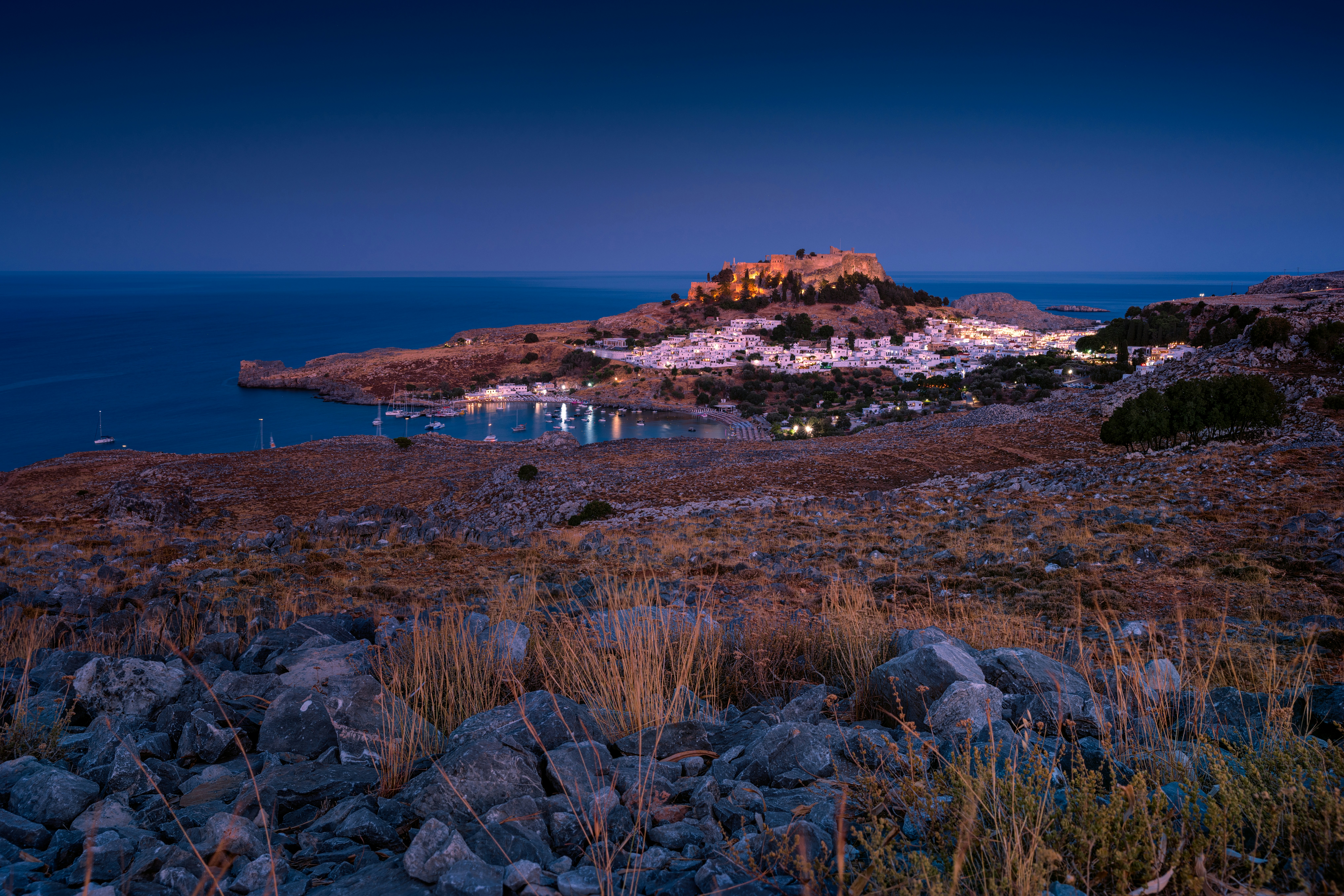 Lindos at night, with the white village and acropolis lit up