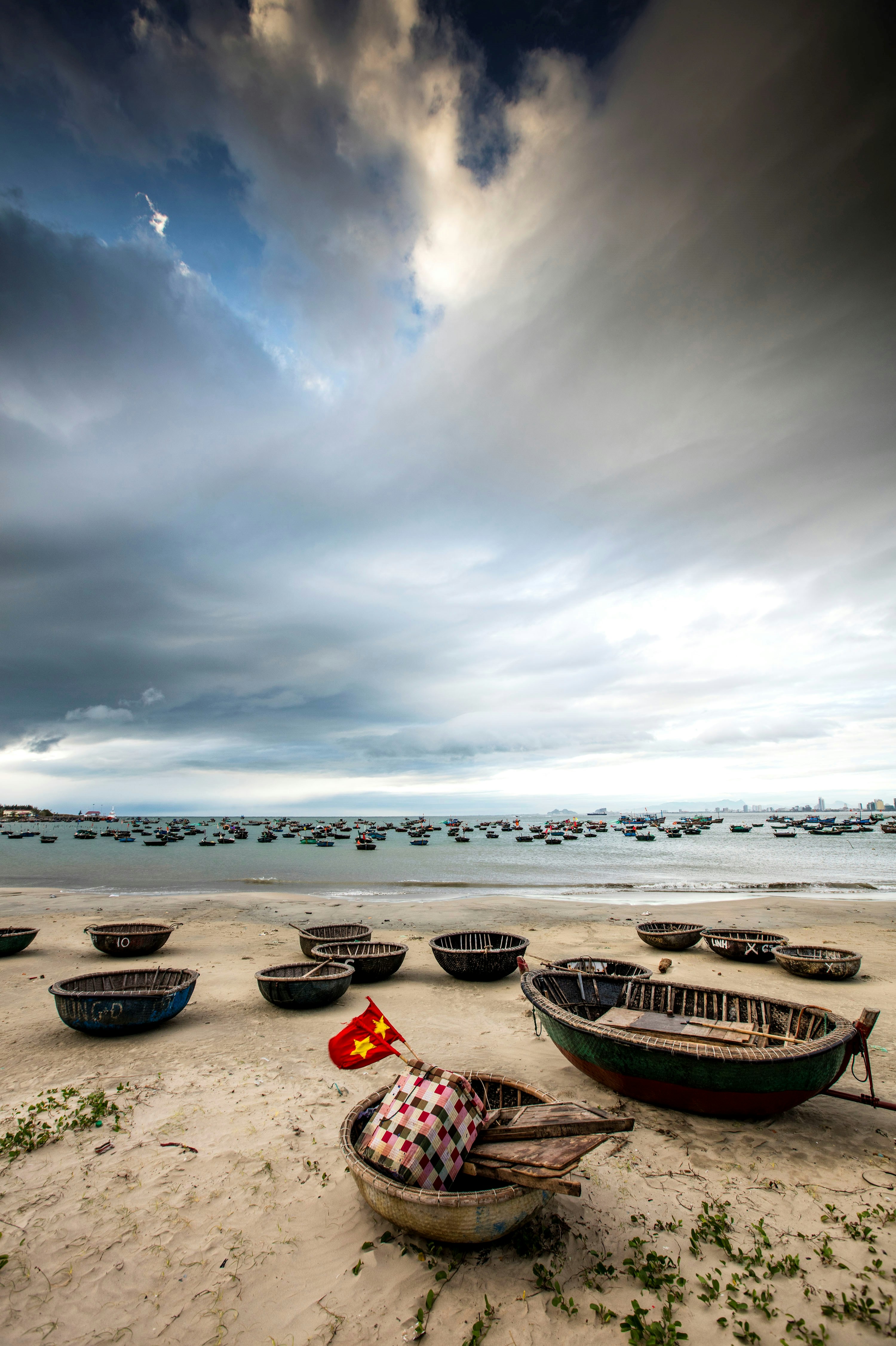 A group of boats sitting on top of a sandy beach