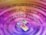 A cell phone sitting on top of a purple circle