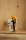 A small figurine of a man with a yellow hat