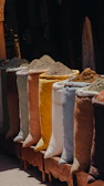 A row of bags of spices sitting next to each other
