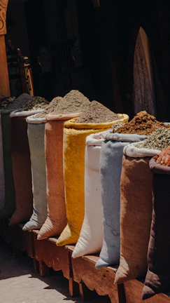 A row of bags of spices sitting next to each other