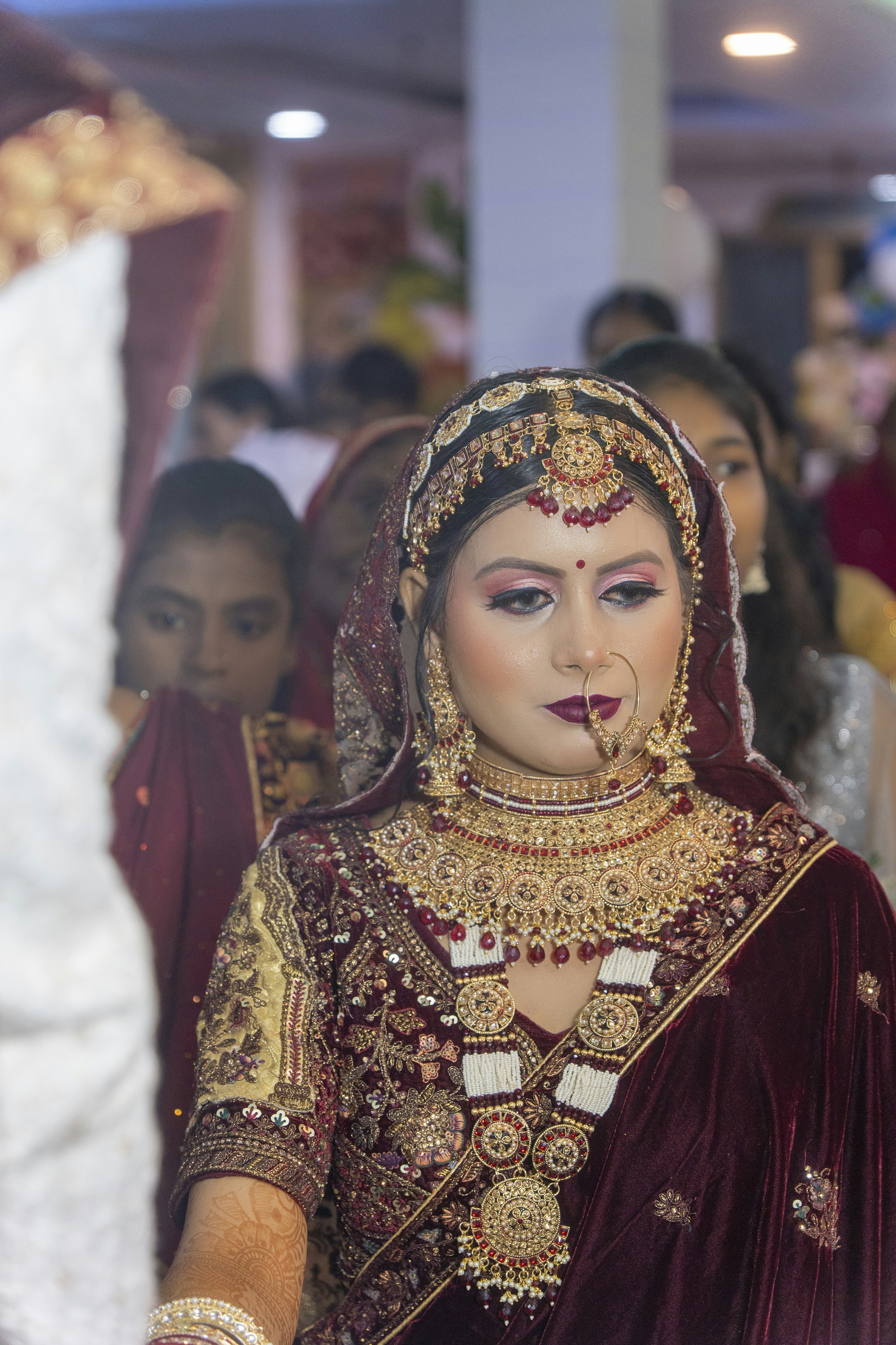 A woman in a red and gold wedding outfit