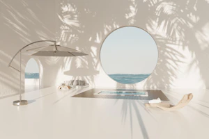 A white table with a mirror and umbrella on it