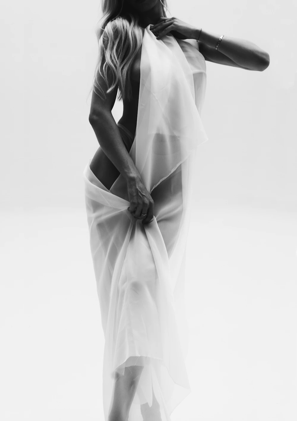 Editorial fashion photograph, silk garments in warm natural light, refined and sensual