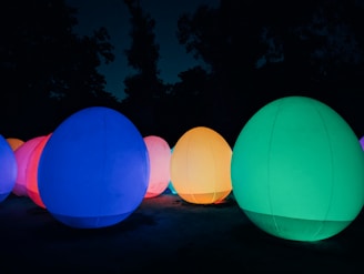 A row of illuminated balls in the dark