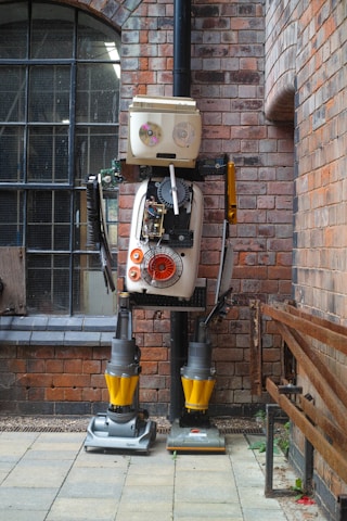 A robot standing in front of a brick building