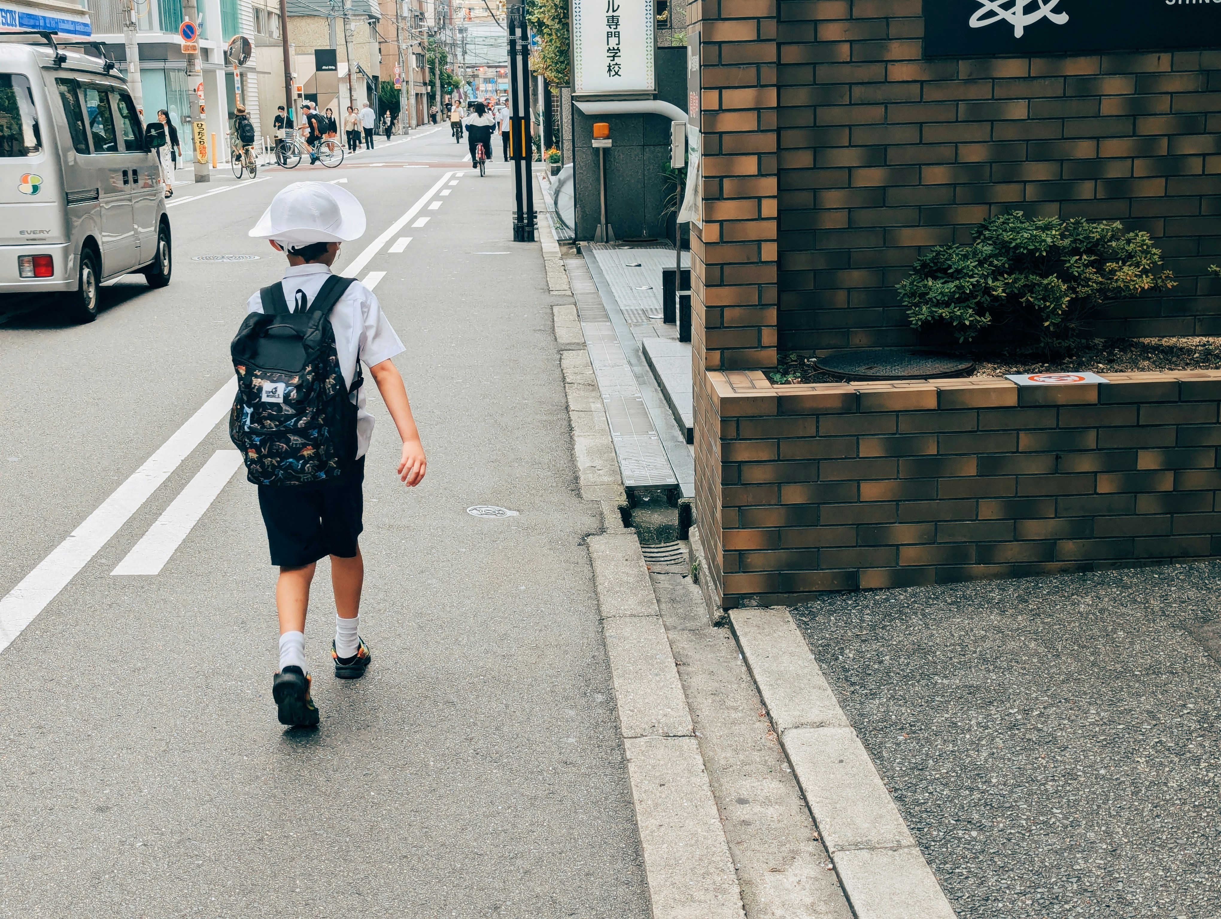 A person walking down a street with a backpack