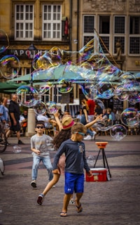A group of children playing with bubbles in the street