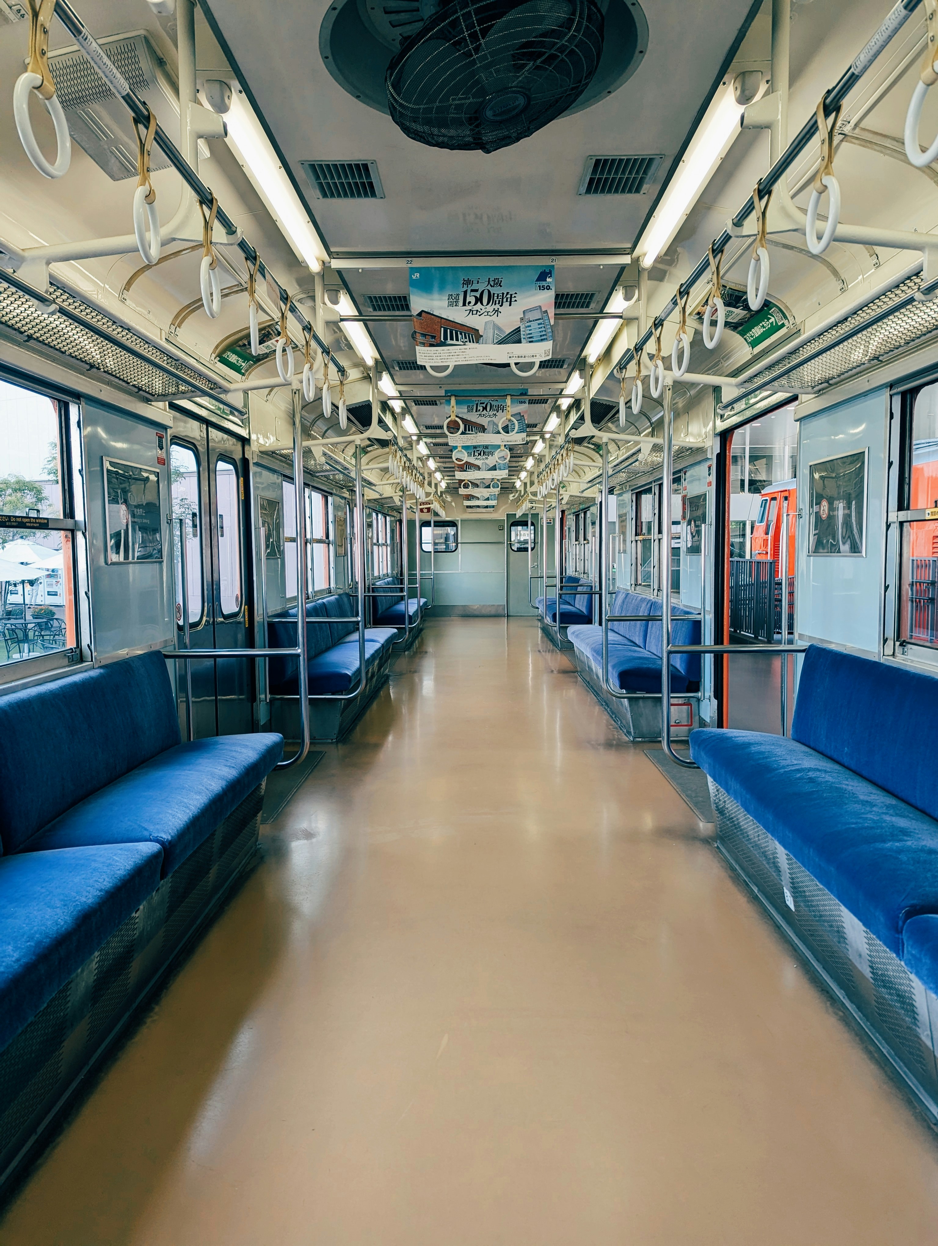 A train car with blue seats and windows