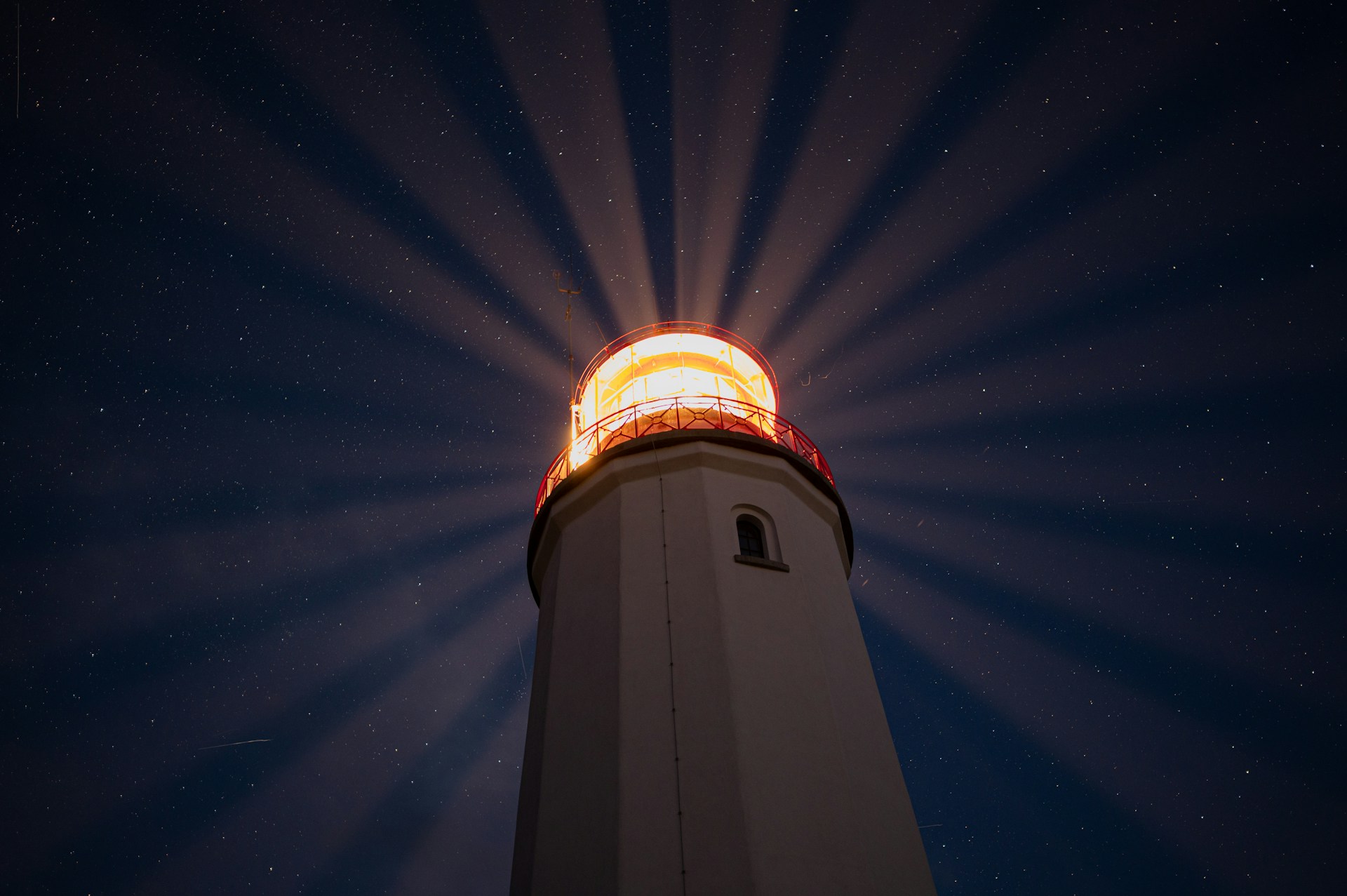 A lighthouse with a bright light shining on top of it