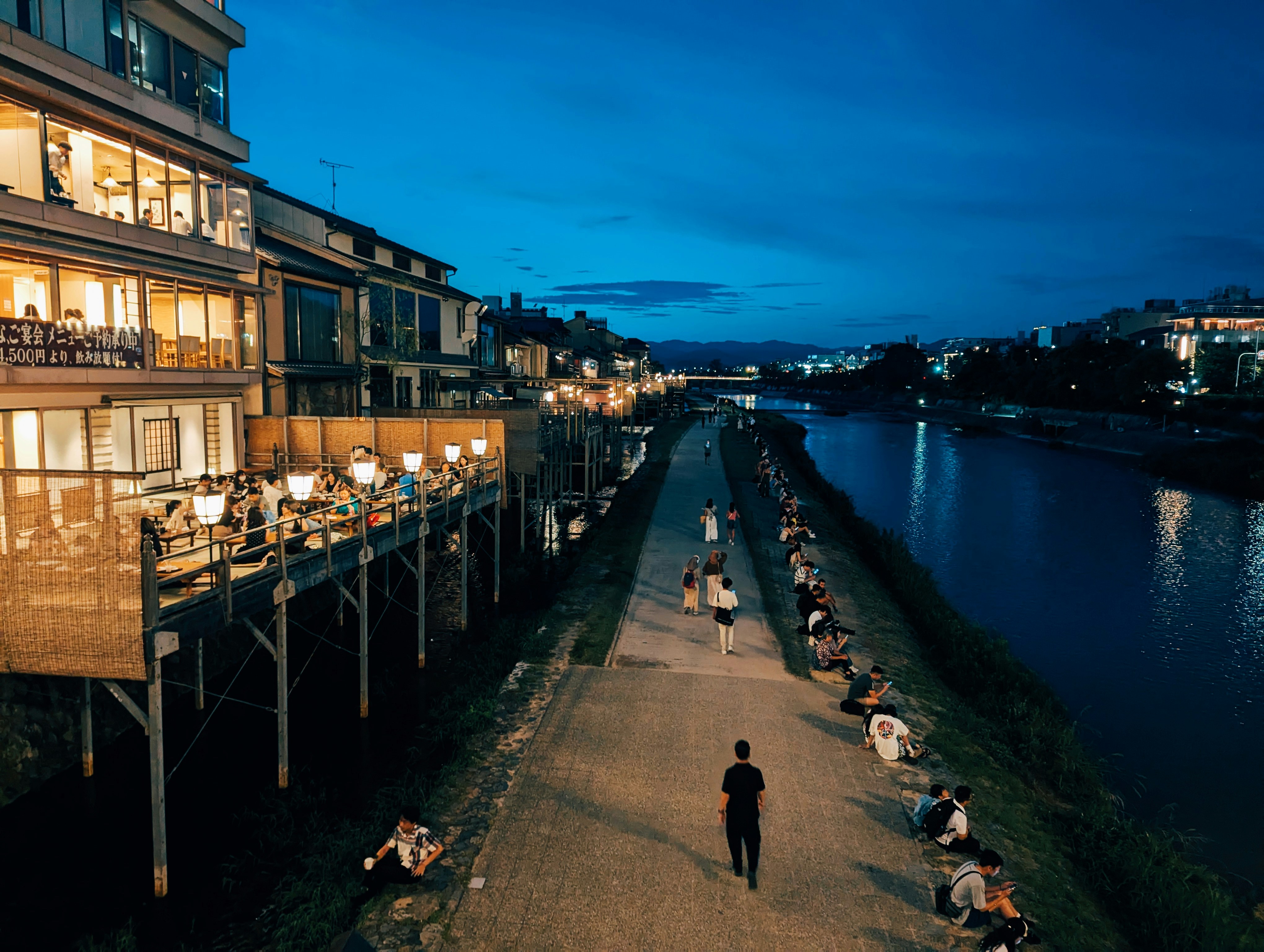 A person walking down a path next to a body of water