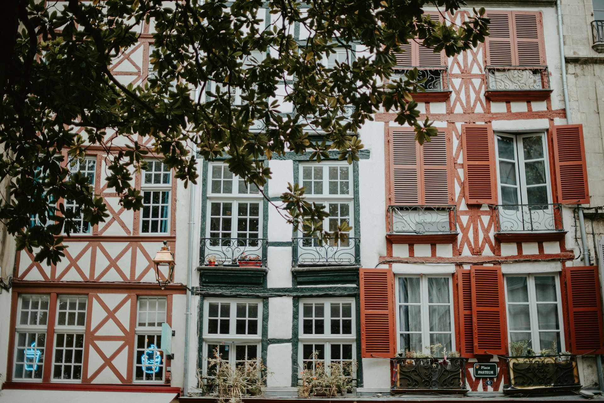A building with red and white shutters and windows