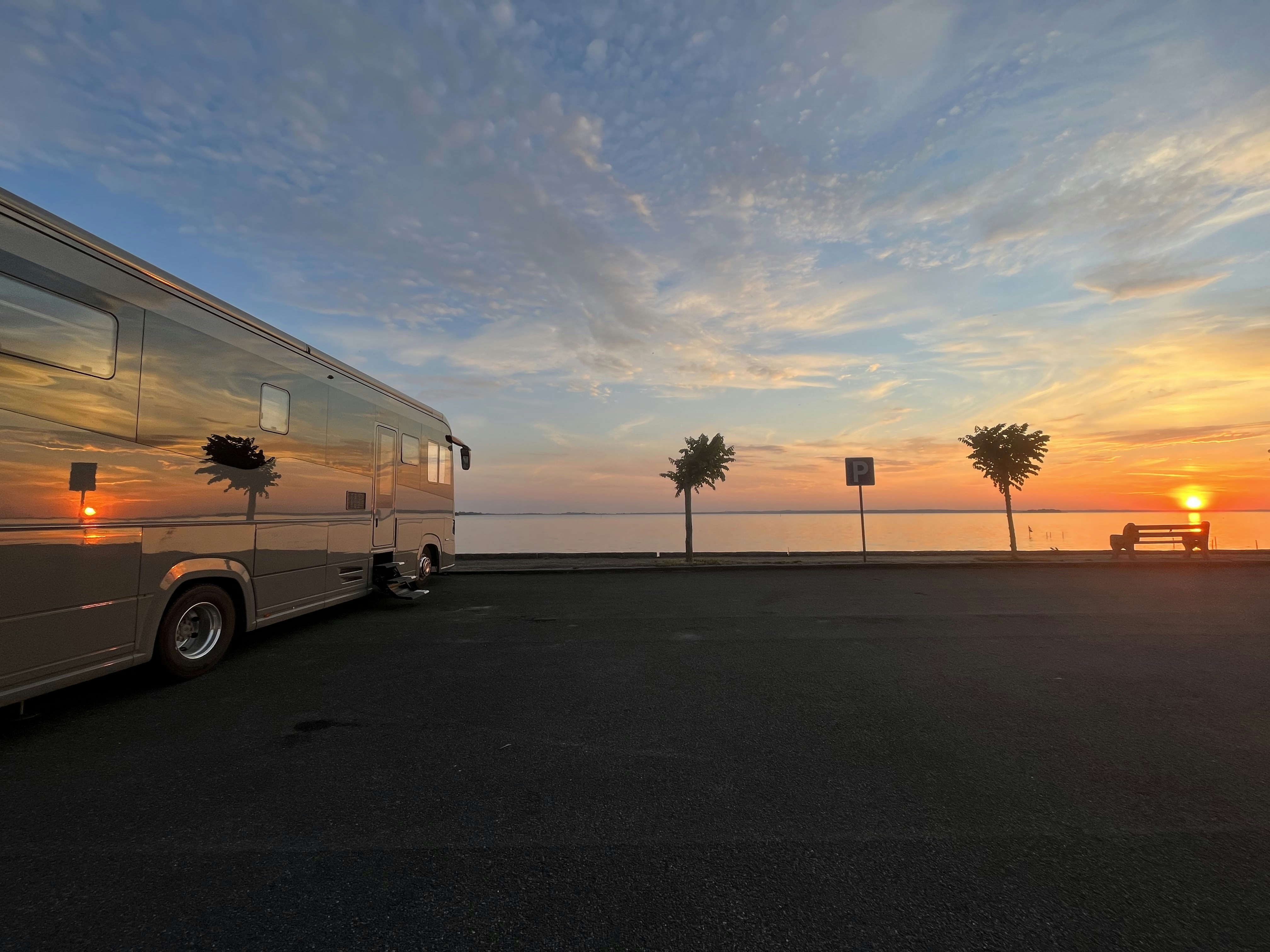 A bus parked on the side of a road near the ocean