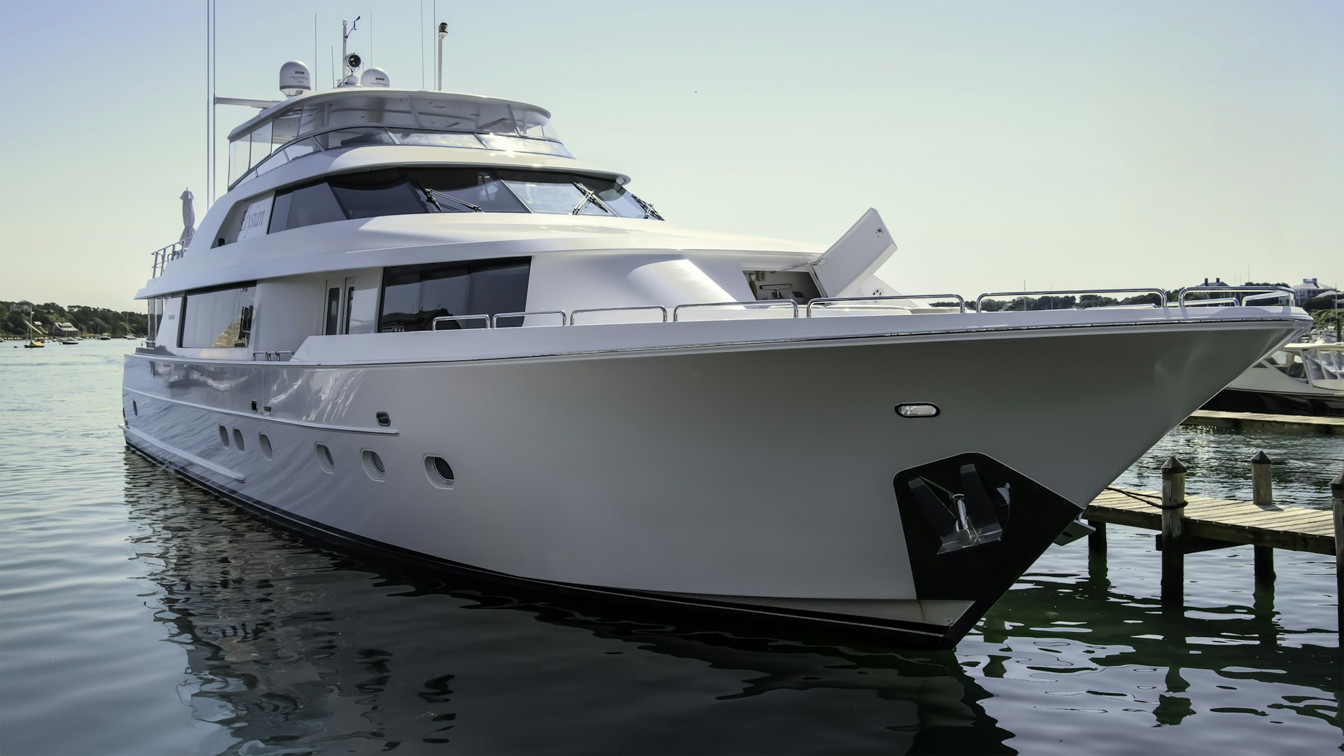 A large white boat docked at a dock