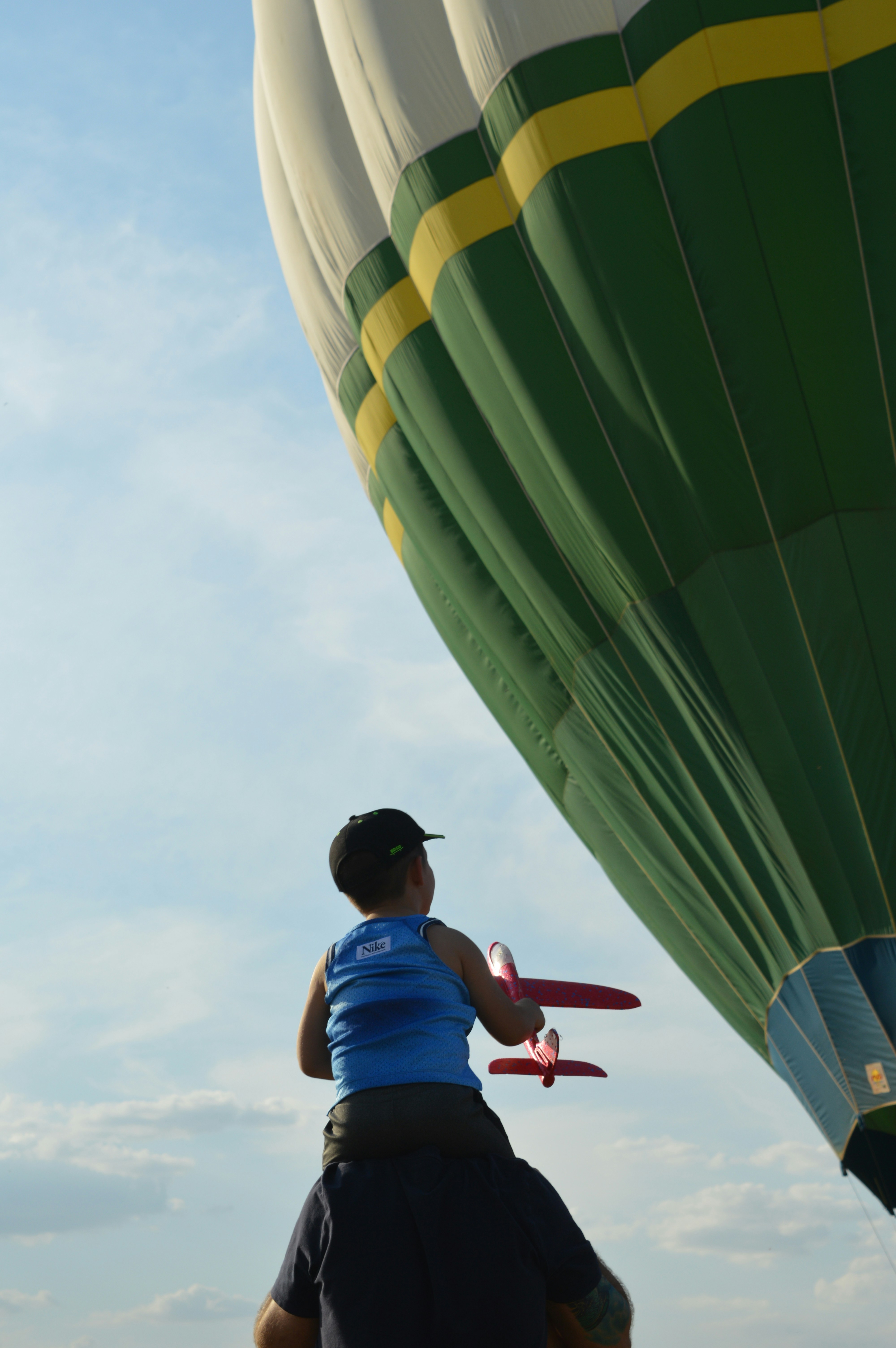 A man and a child flying a large hot air balloon