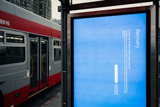 A bus stop with a bus parked next to it