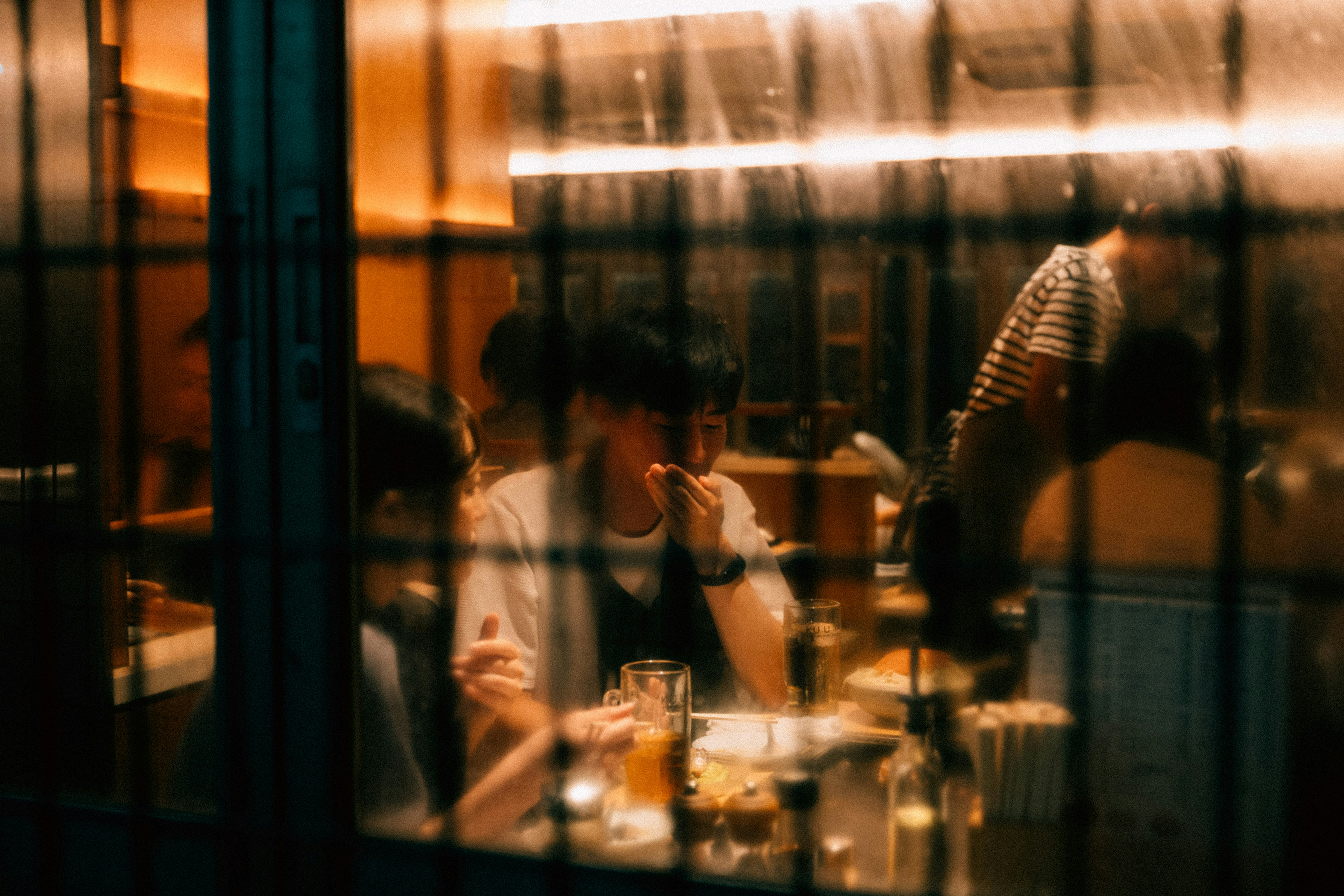 A group of people sitting at a table in a restaurant