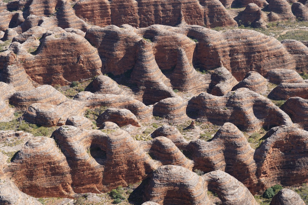A large group of rock formations in the desert, Flying over the bungle bungles in a helicopter