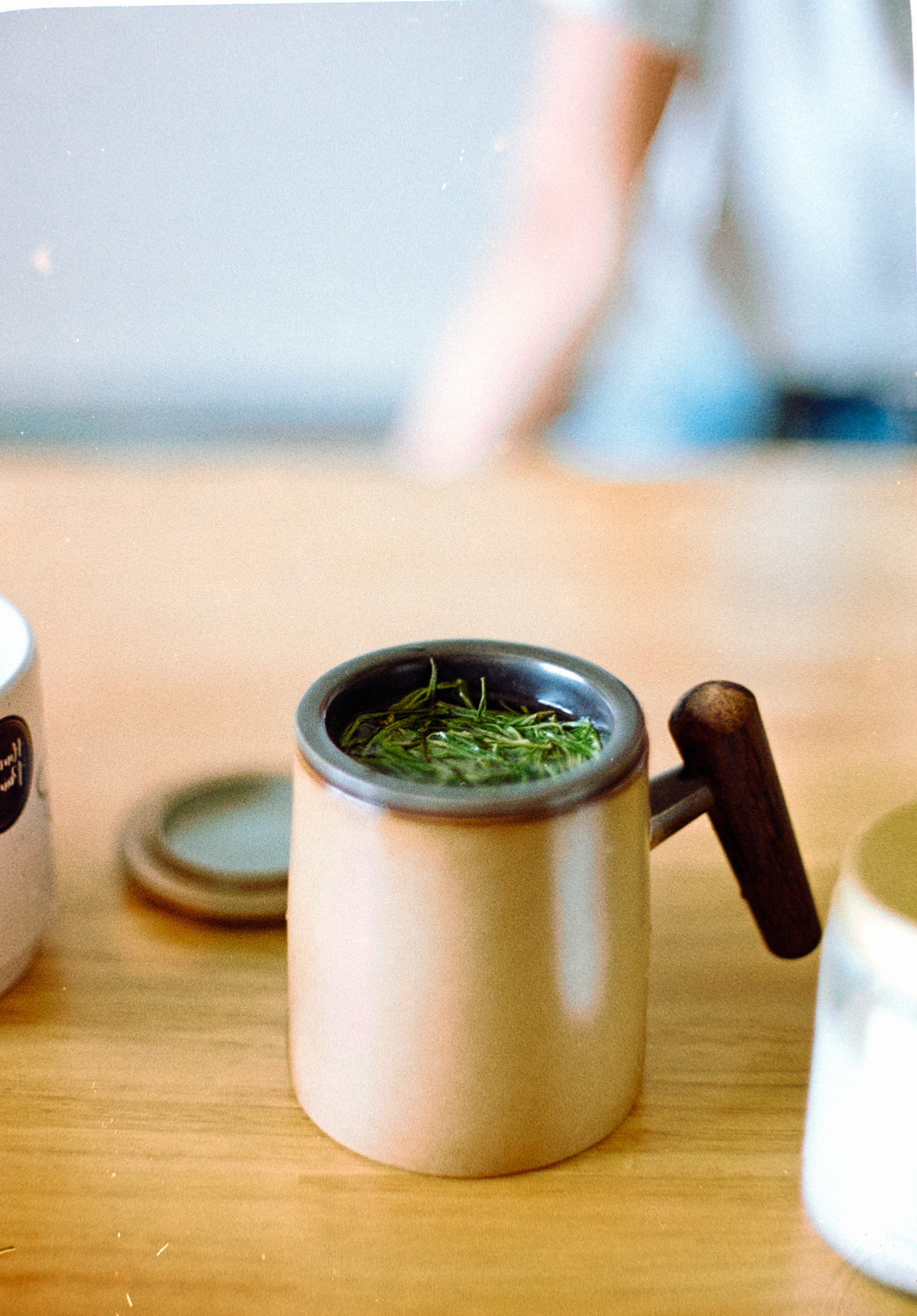 A wooden table topped with two jars of food