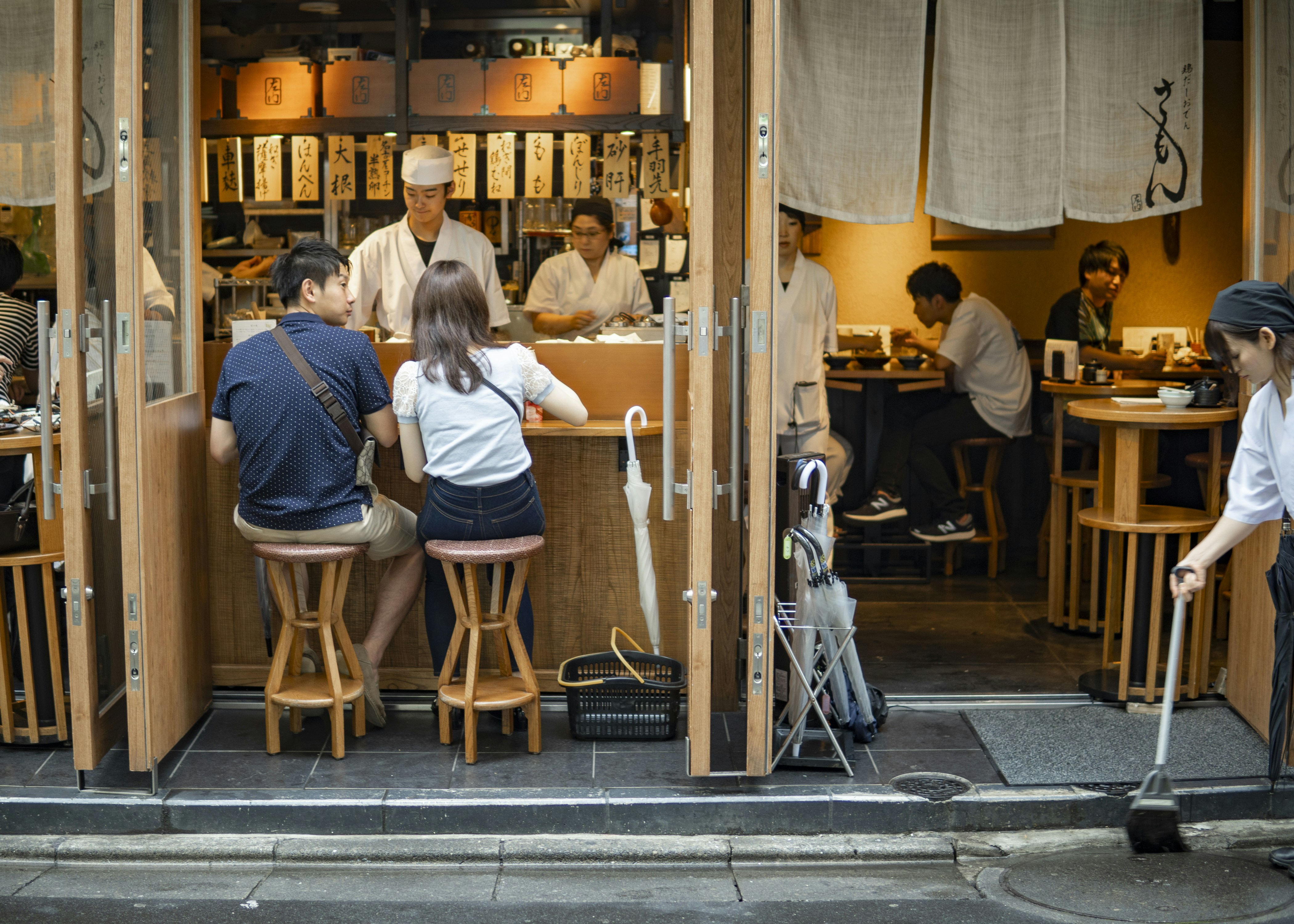 A group of people sitting at a table in a restaurant