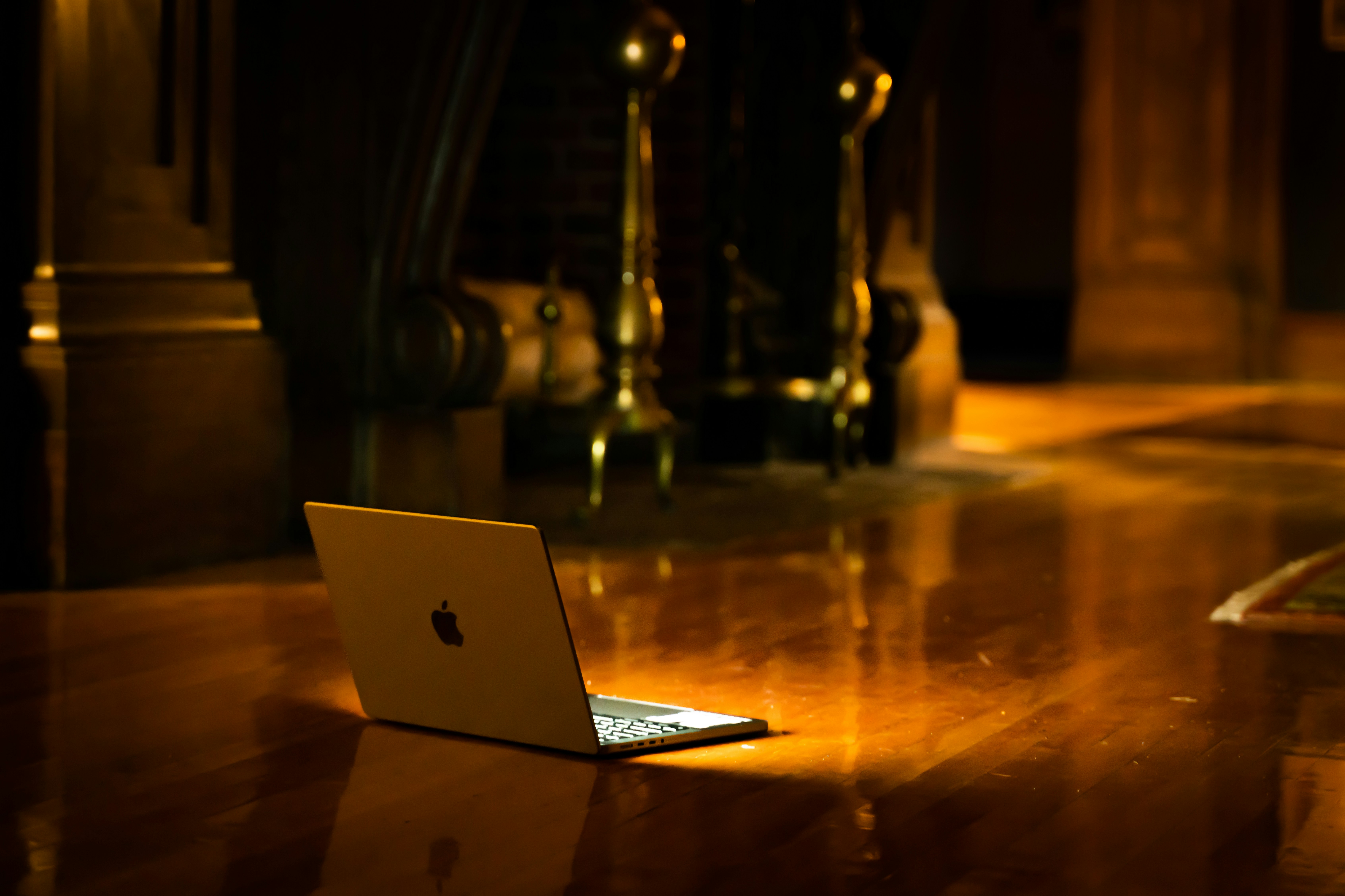 A laptop computer sitting on top of a wooden table