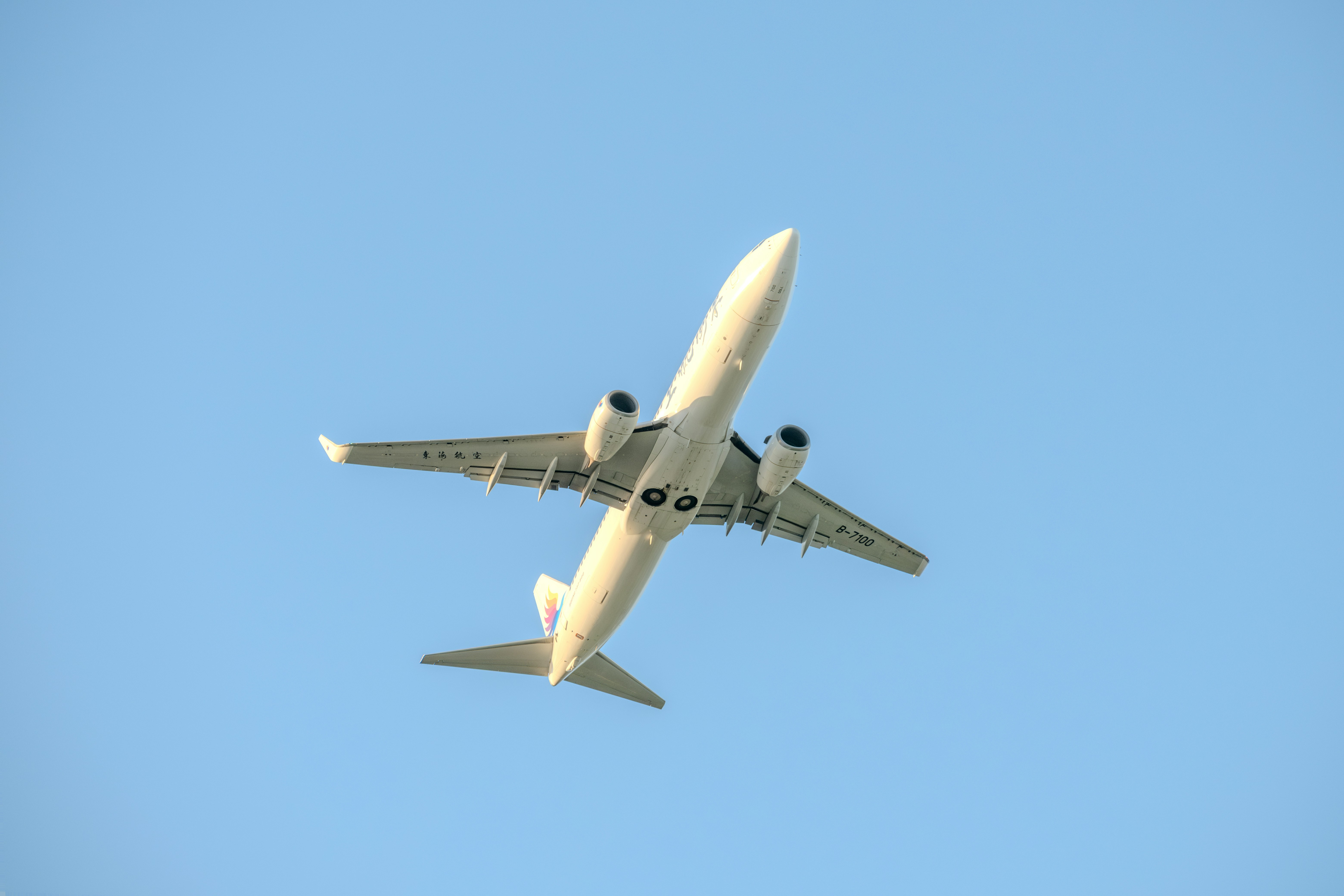 A large jetliner flying through a blue sky, 