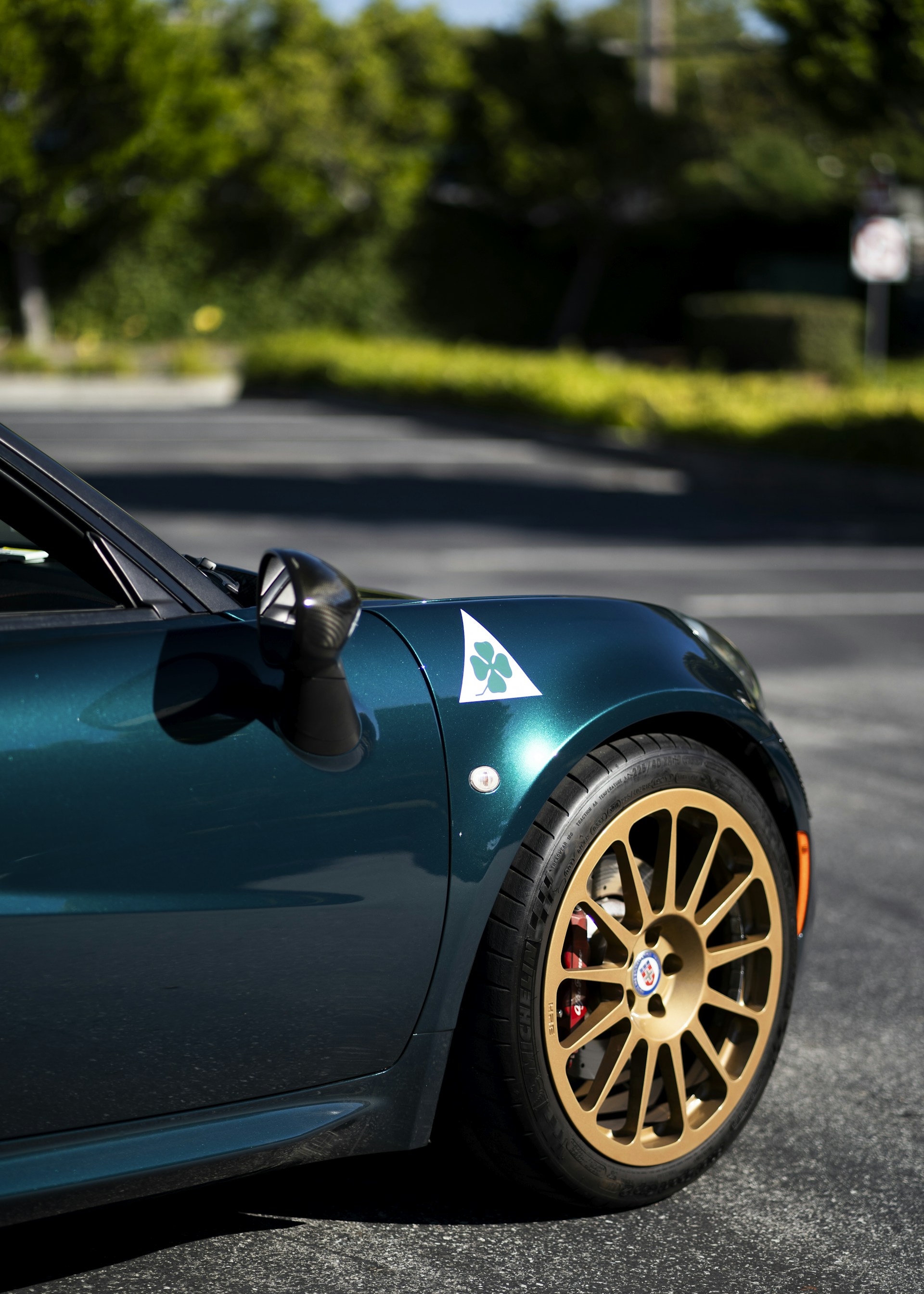 A blue sports car parked on the side of the road