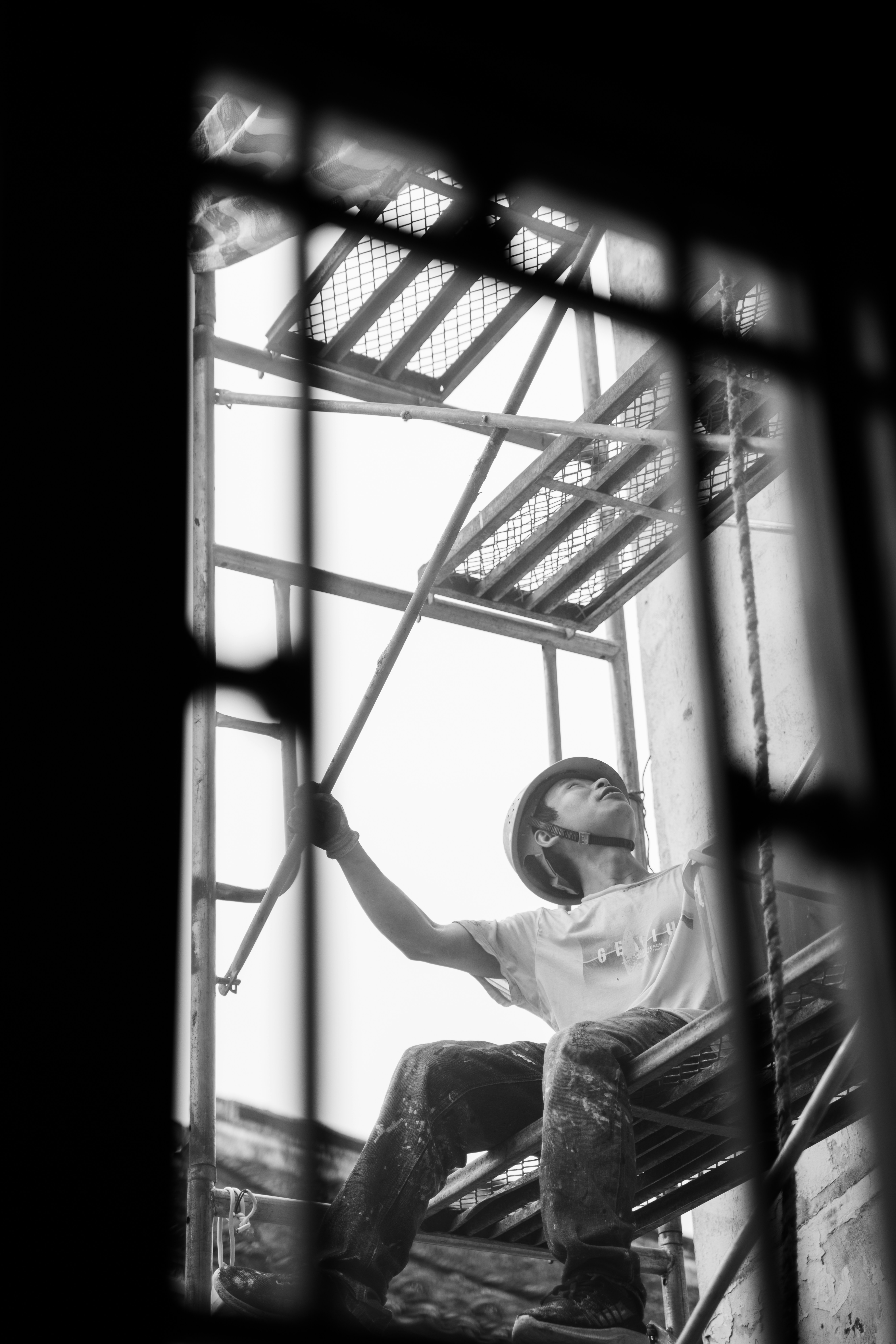 Construction worker on scaffolding looking up