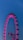 A pink ferris wheel lit up at night
