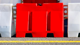 A red and white fire hydrant sitting on the side of a road