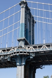 A tall bridge with a clock on it's side