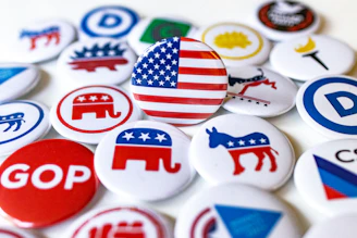 A pile of political buttons sitting on top of a table