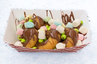 A tray filled with lots of candy covered in chocolate