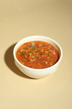 A bowl of soup is sitting on a table