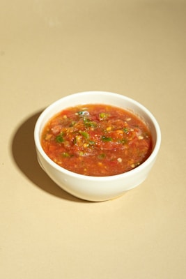 A bowl of soup is sitting on a table