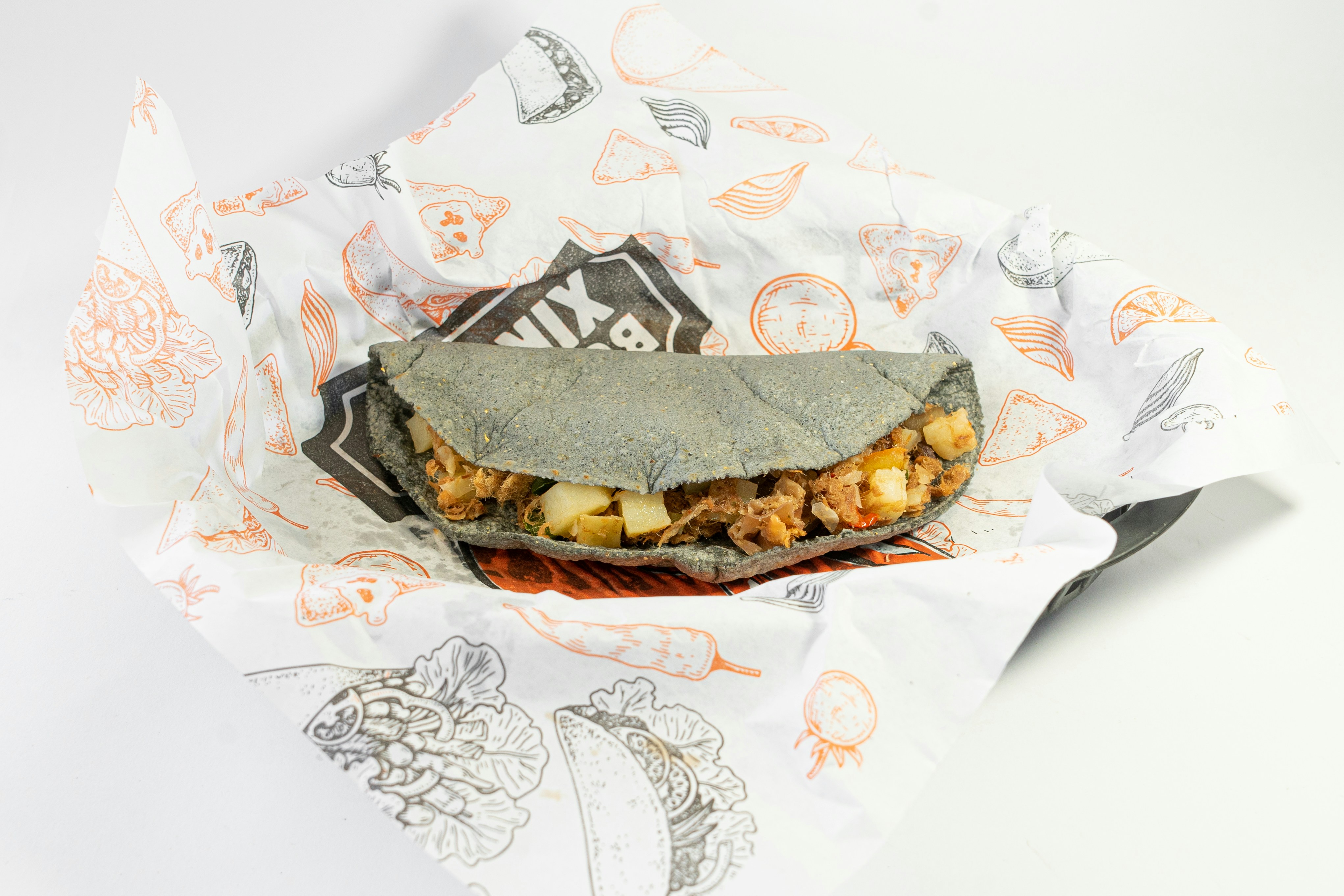 Filled flatbread in paper wrap
