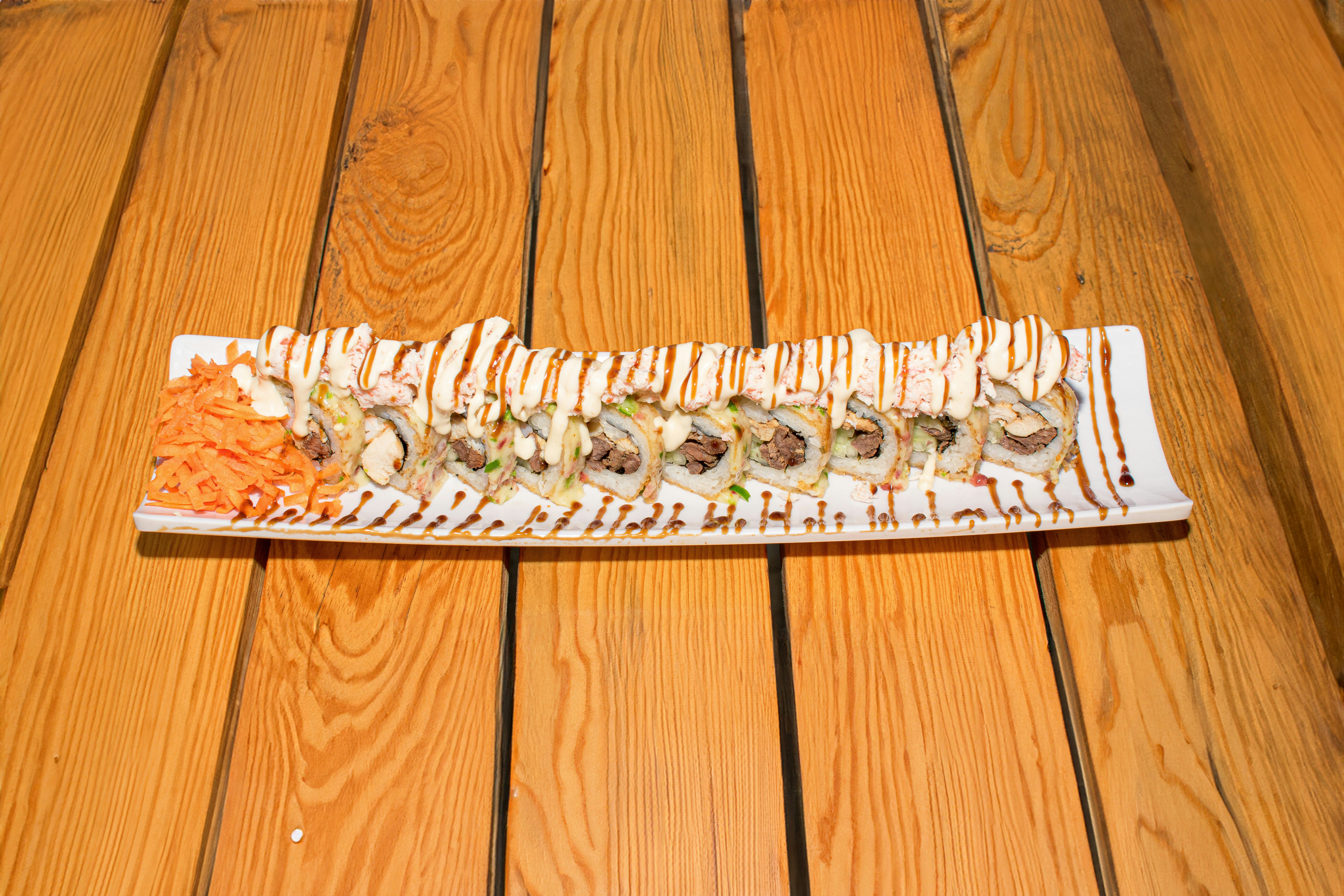 Sushi rolls lined up on a long platter