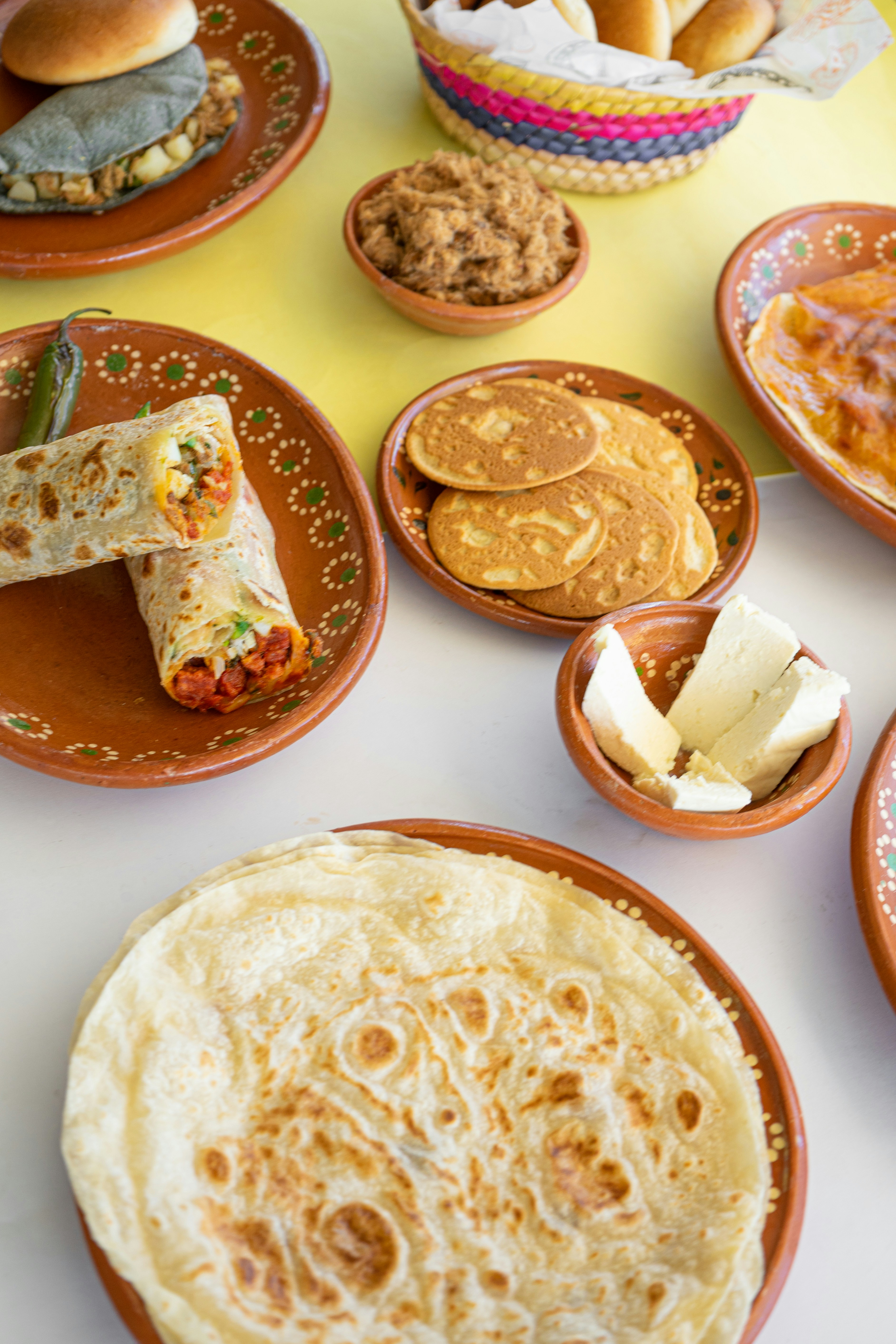 A table topped with plates filled with different types of food