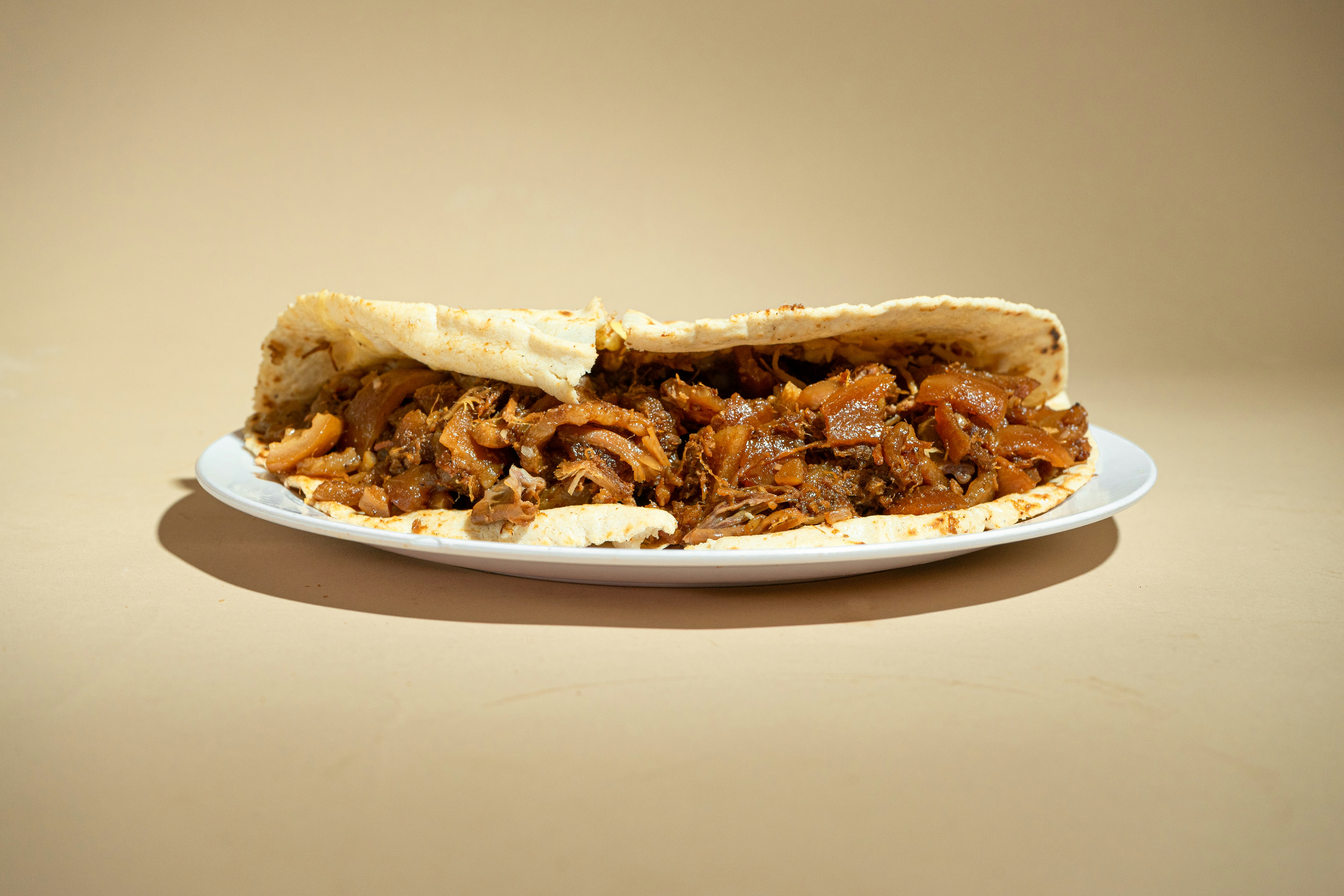 A plate with a half eaten sandwich on it