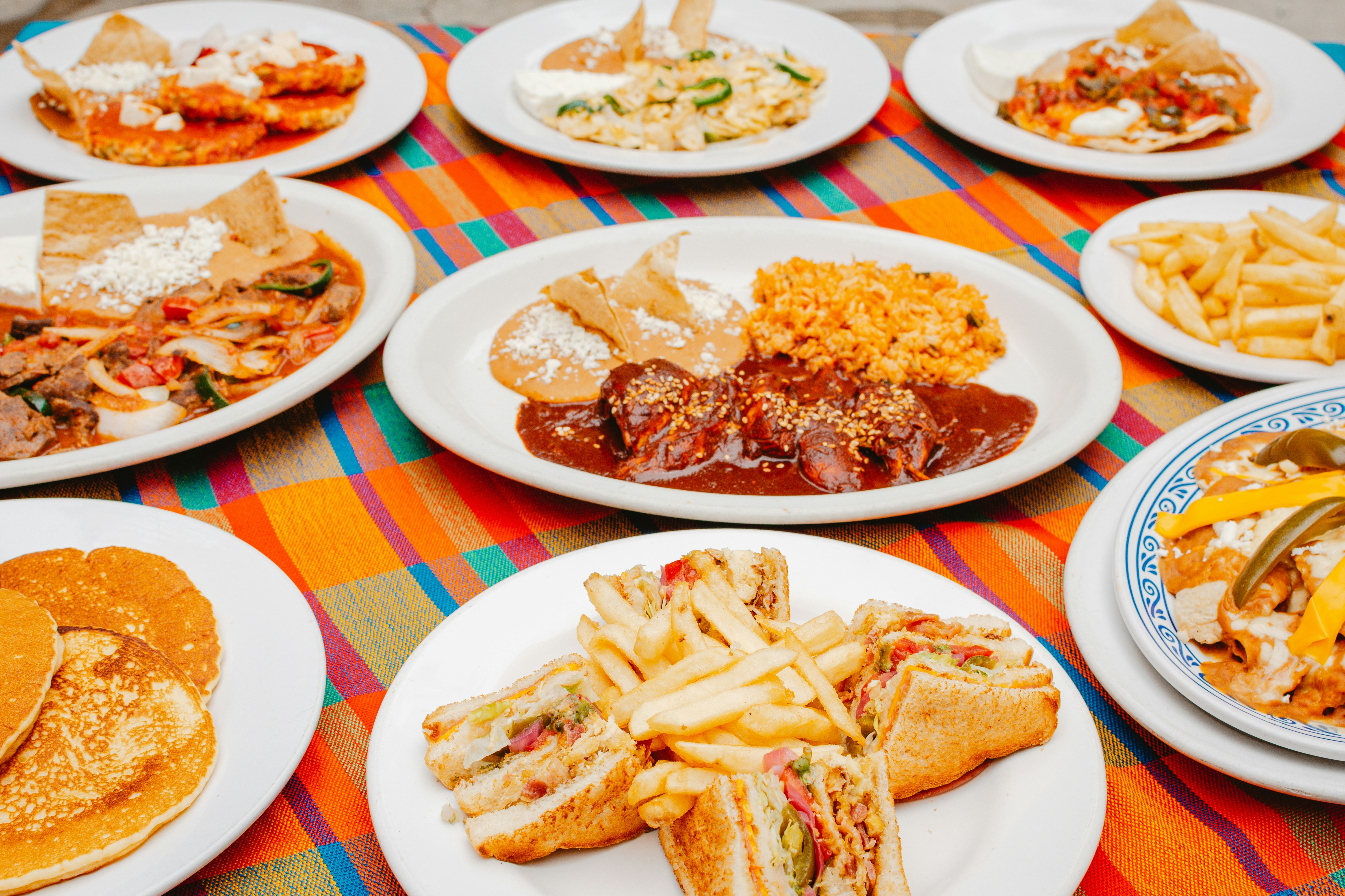 Four-person takeout spread showing family-style portions from various Chicago restaurants - Chicago takeout options