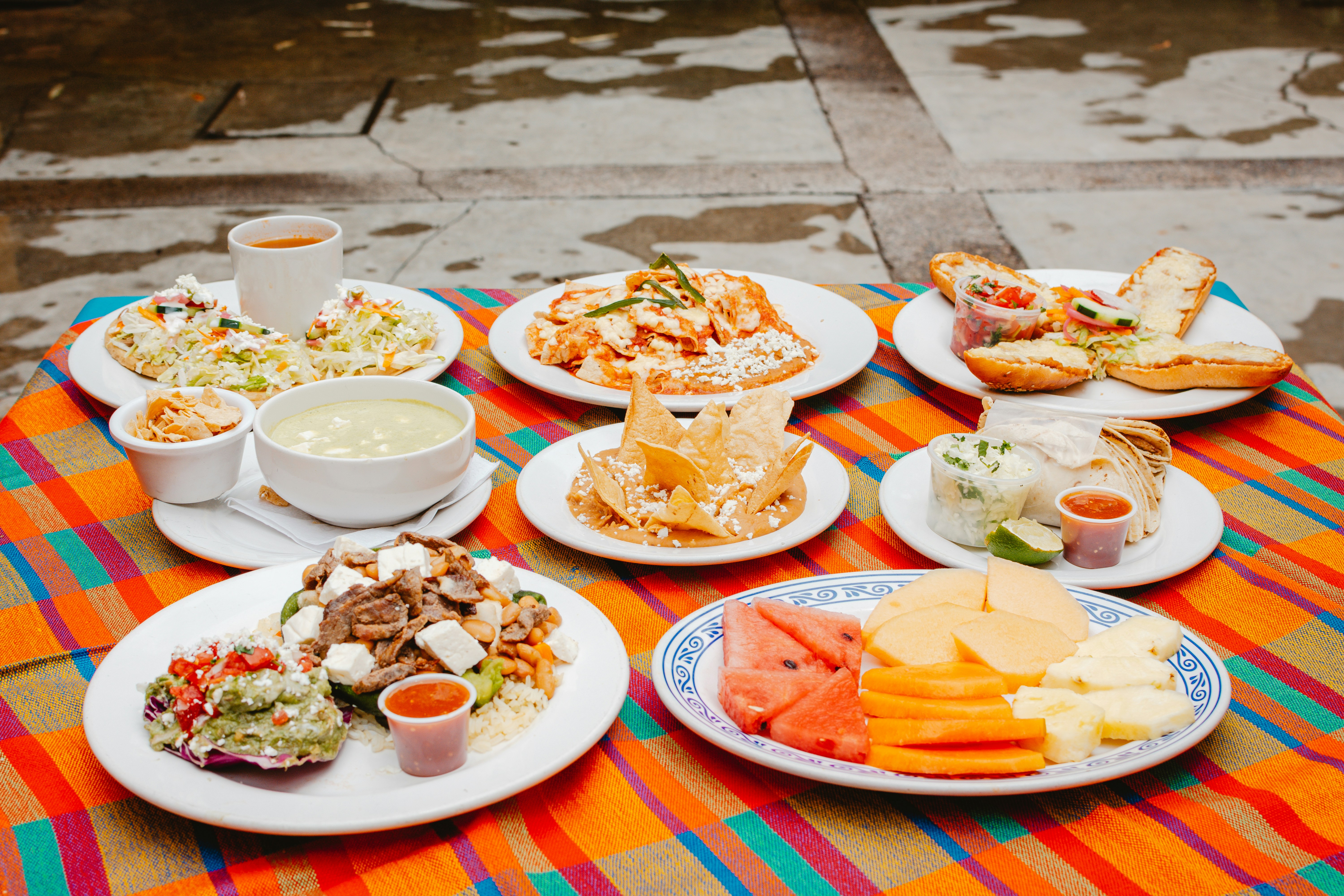 A table topped with lots of plates of food