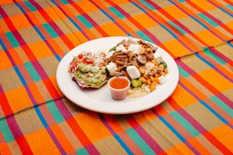 A plate of food on a colorful table cloth
