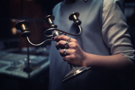 A person holding a pair of scissors in their hands