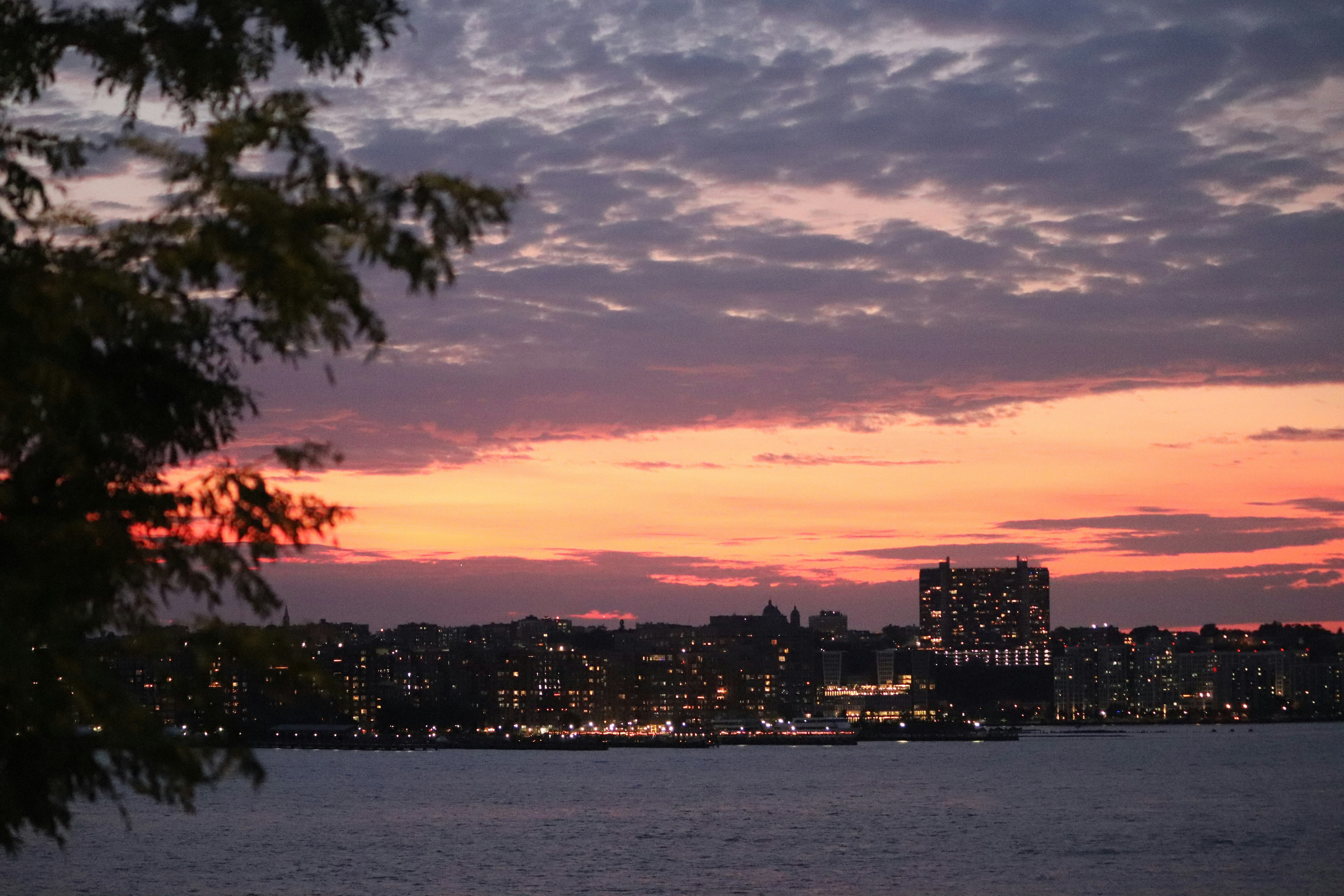 A view of a city at dusk from across the water